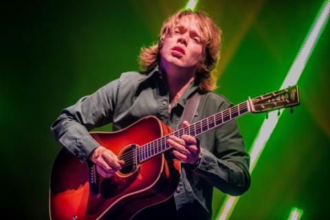 Billy Strings playing his guitar with the passion of a poet 